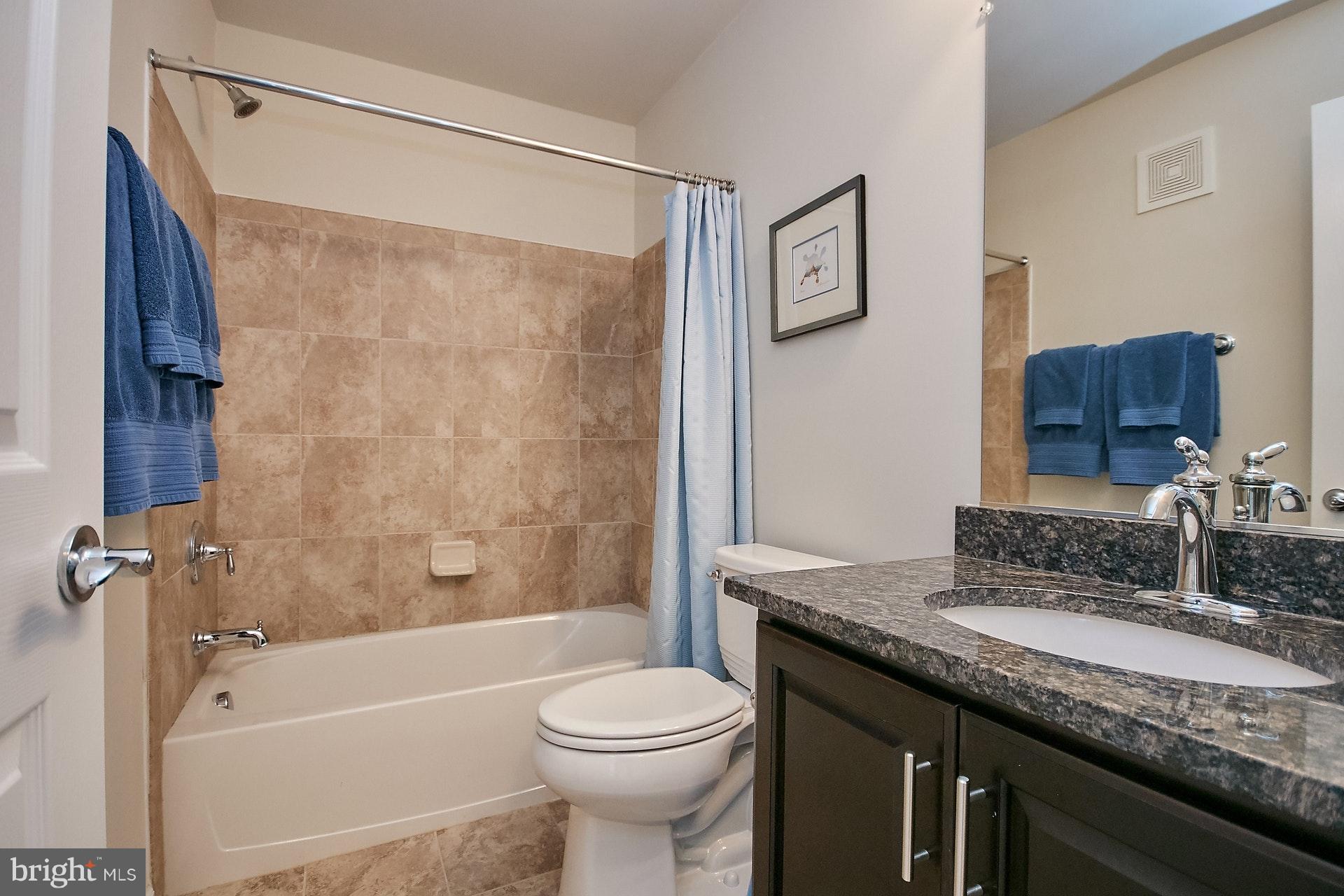 3073 Rittenhouse Circle, Unit 60 Fairfax, VA 22031 - Photo 27 of 30 a bathroom with a granite countertop sink toilet and shower