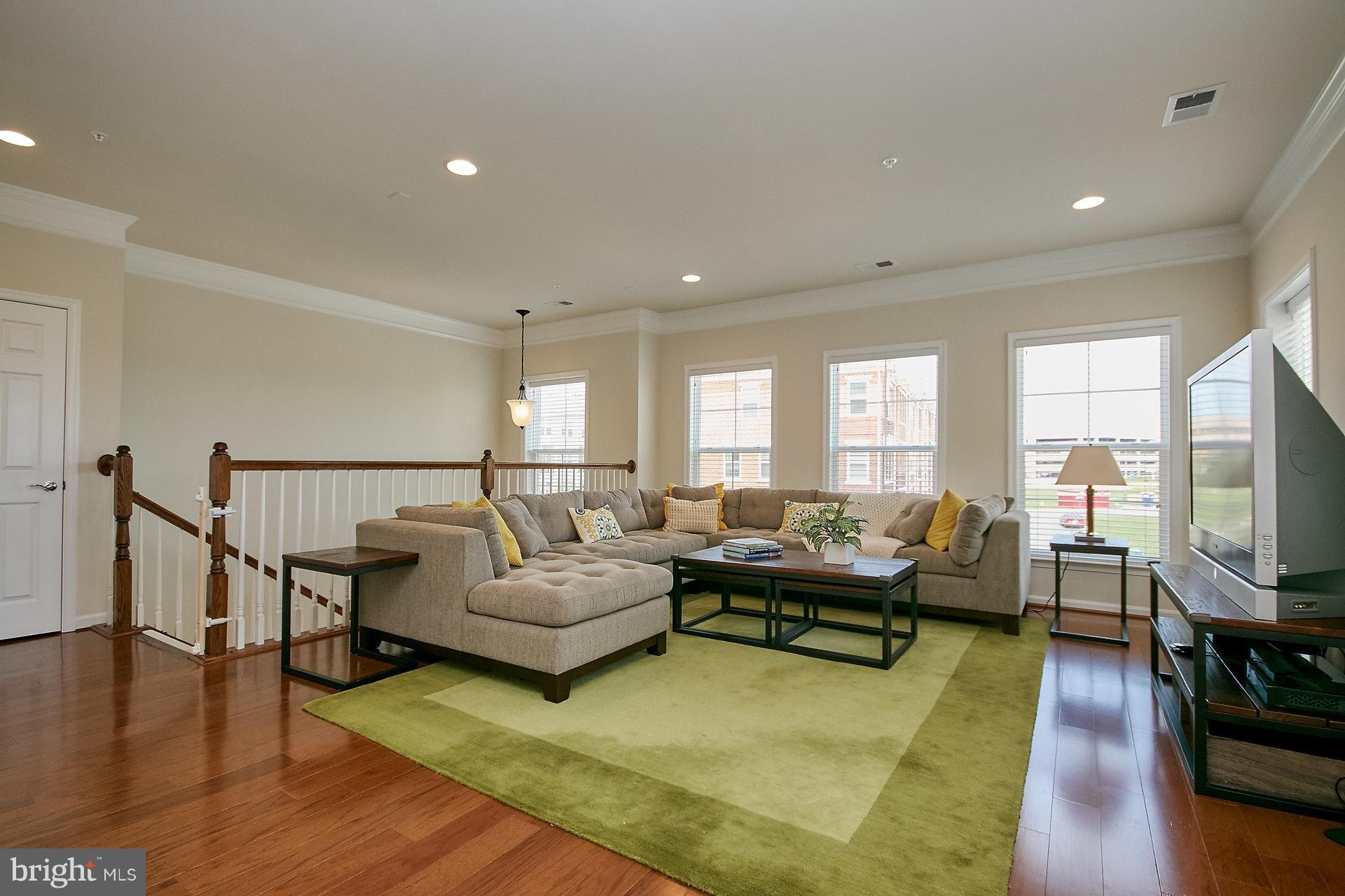 3073 Rittenhouse Circle, Unit 60 Fairfax, VA 22031 - Photo 3 of 30 a living room with furniture flat screen tv and wooden floor