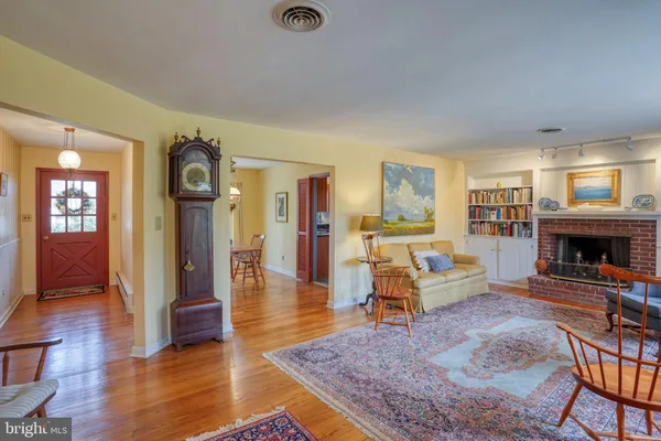 a dining room with furniture a chandelier and wooden floor