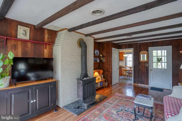 a view of a hallway with wooden floor and a dining room