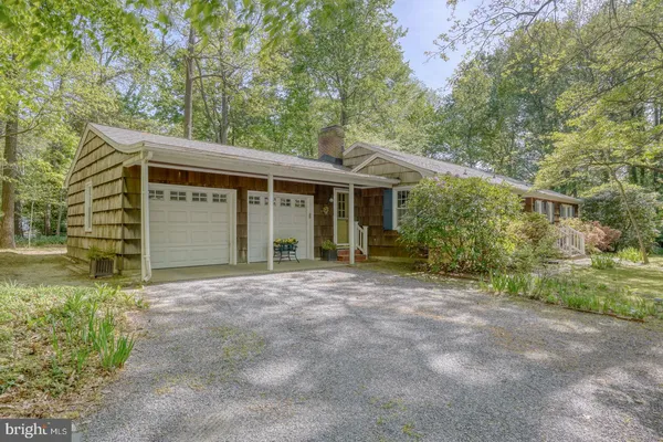 a view of a house with backyard sitting area and garden
