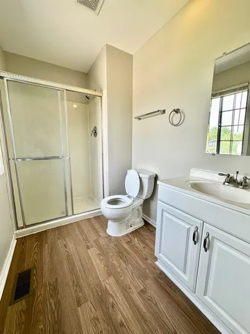 a bathroom with a sink mirror vanity and toilet