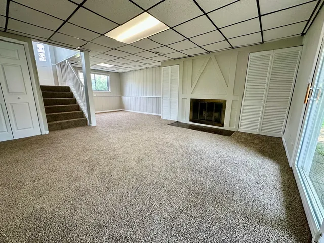 a view of an empty room with a fireplace