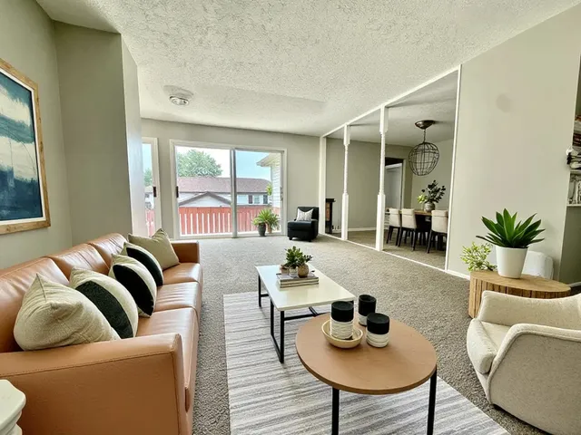 a living room with furniture and a potted plant