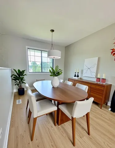 a view of a dining room with furniture and window