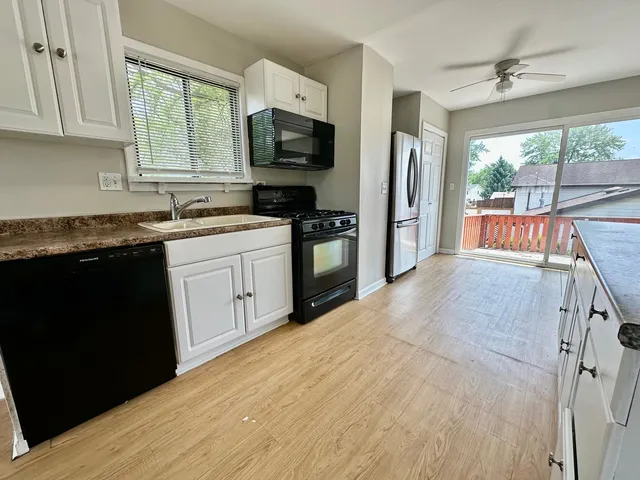 a kitchen with stainless steel appliances granite countertop a stove a sink dishwasher a refrigerator and a microwave