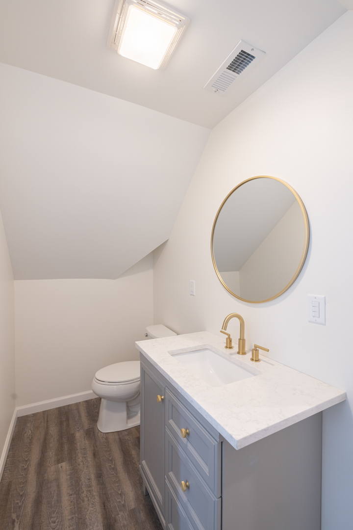 394 West Hawkins Street Kankakee, IL 60901 - Photo 13 of 26 a bathroom with a sink a toilet and a mirror