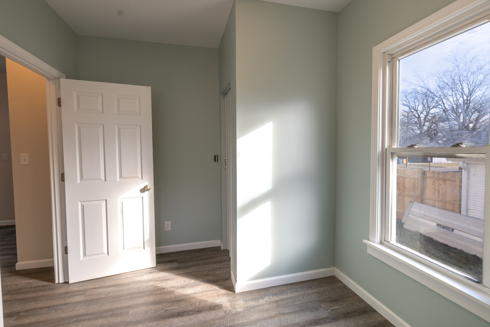394 West Hawkins Street Kankakee, IL 60901 - Photo 17 of 26 an empty room with wooden floor and windows