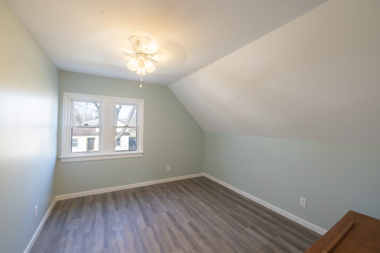 394 West Hawkins Street Kankakee, IL 60901 - Photo 21 of 26 an empty room with wooden floor and windows