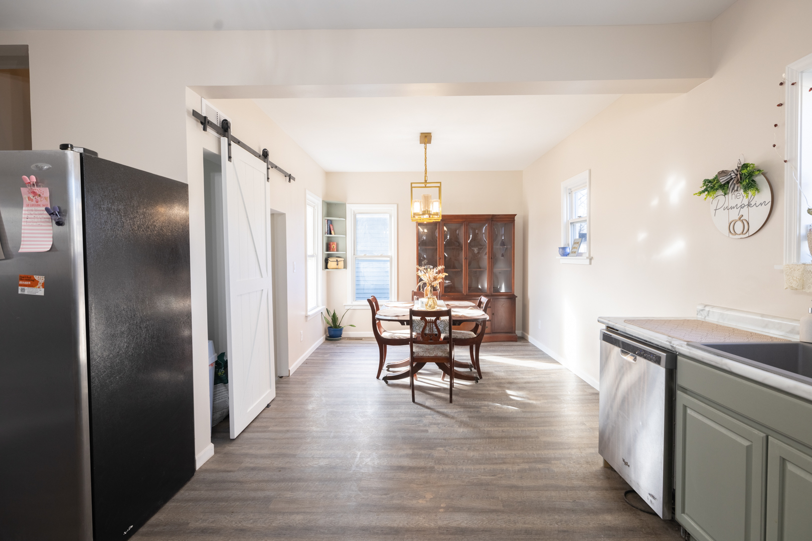 394 West Hawkins Street Kankakee, IL 60901 - Photo 6 of 26 a kitchen with stainless steel appliances granite countertop a refrigerator a stove and a dining table with wooden floor