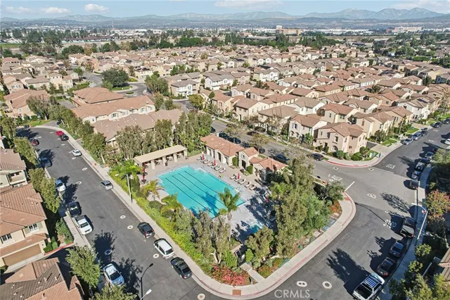 an aerial view of a residential houses with street