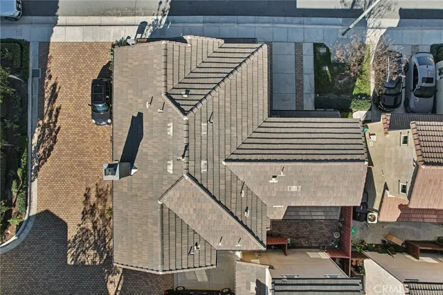 an aerial view of a house with a yard and ocean view