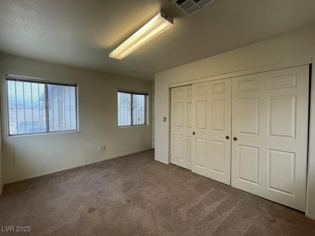 3530 North Pecos Road Las Vegas, NV 89115 - Photo 44 of 46 Unfurnished bedroom with carpet floors, a closet, visible vents, and baseboards