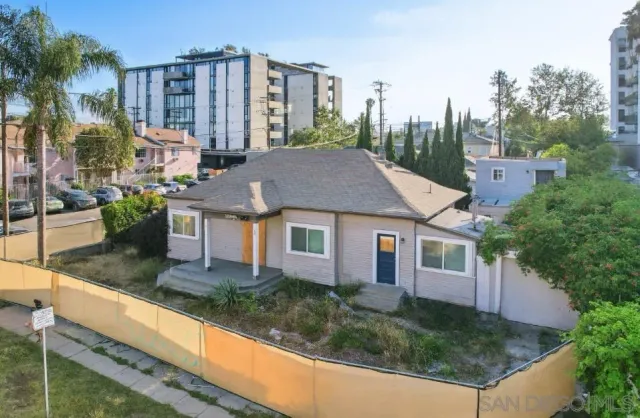 a aerial view of a house with yard and swimming pool