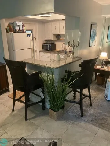 a kitchen with granite countertop a sink a stove and cabinets