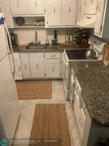 a living room with furniture a rug and a window