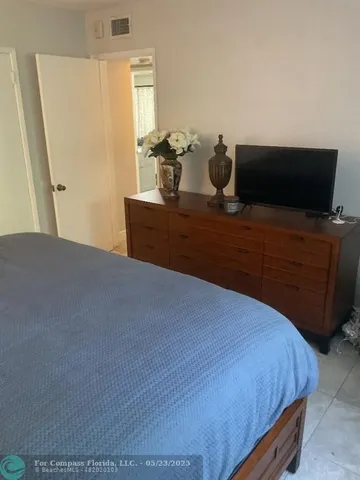 a white toilet sitting next to a shower curtain