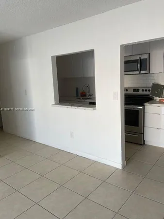 a view of a living room with a flat screen tv and washer
