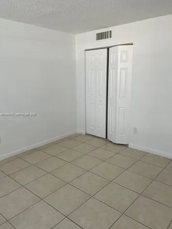 an empty room with wooden floor