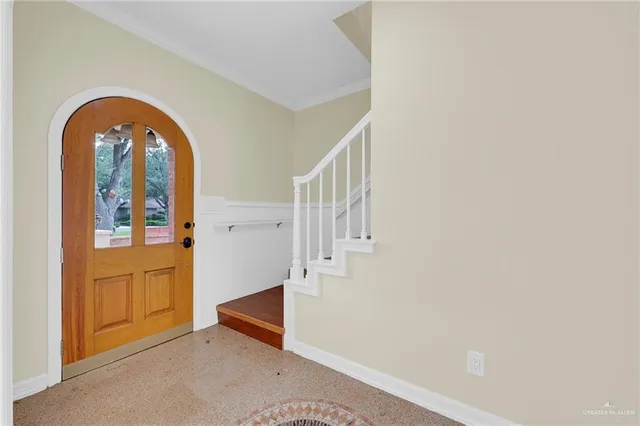 an entryway with wooden floor and a living room