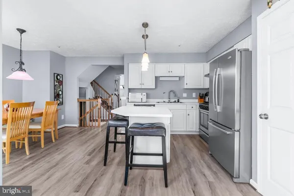 a kitchen with white cabinets and appliances