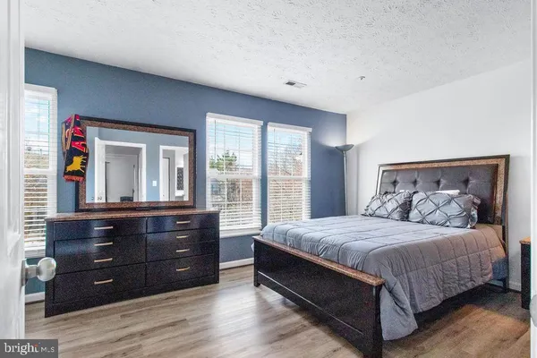 a bedroom with a bed and a mirror