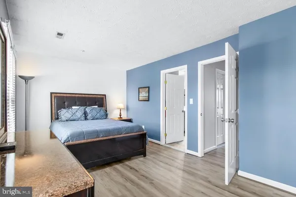 a bedroom with a large bed closet and closet