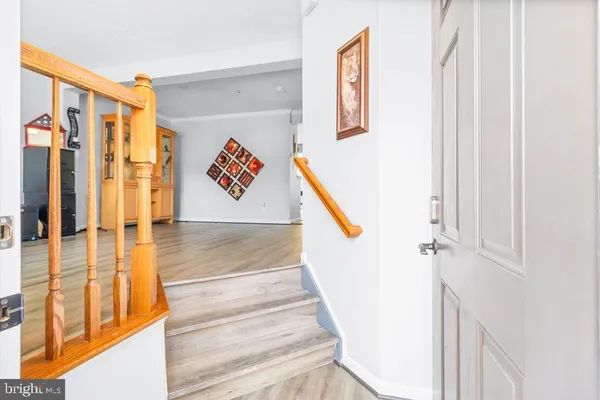 a view of a livingroom with wooden floor and furniture