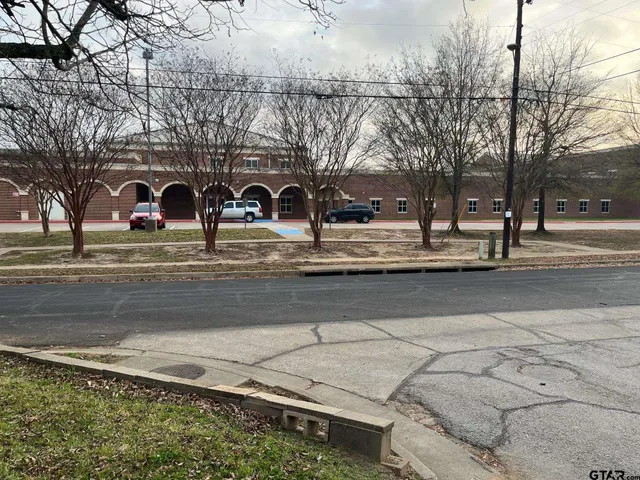 a front view of a building with trees