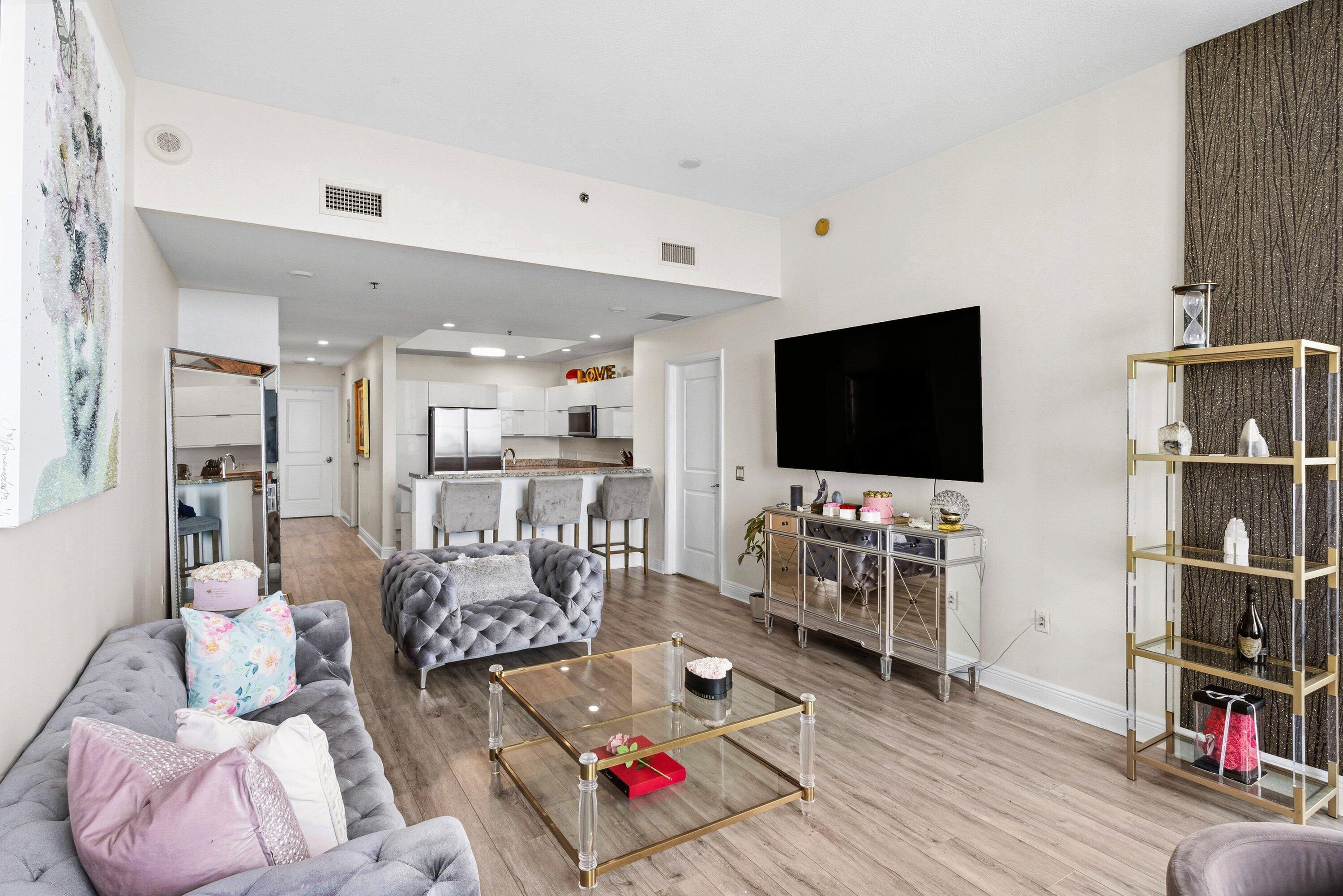 2641 North Flamingo Road, Unit 2701N Sunrise, FL 33323 - Photo 6 of 38 a living room with furniture and a flat screen tv