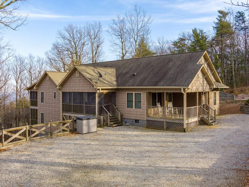 a view of a house with a yard and trees