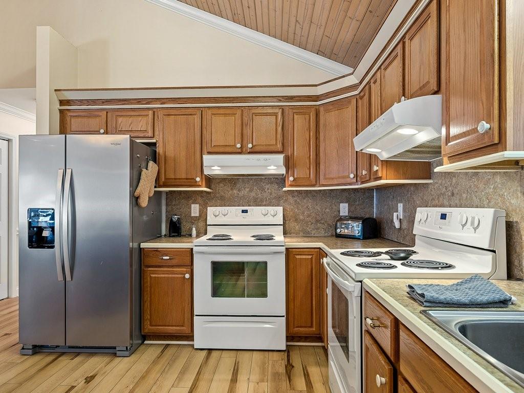 3245 Holly Road Connelly Springs, NC 28612 - Photo 13 of 39 a kitchen with a stove a sink and a refrigerator