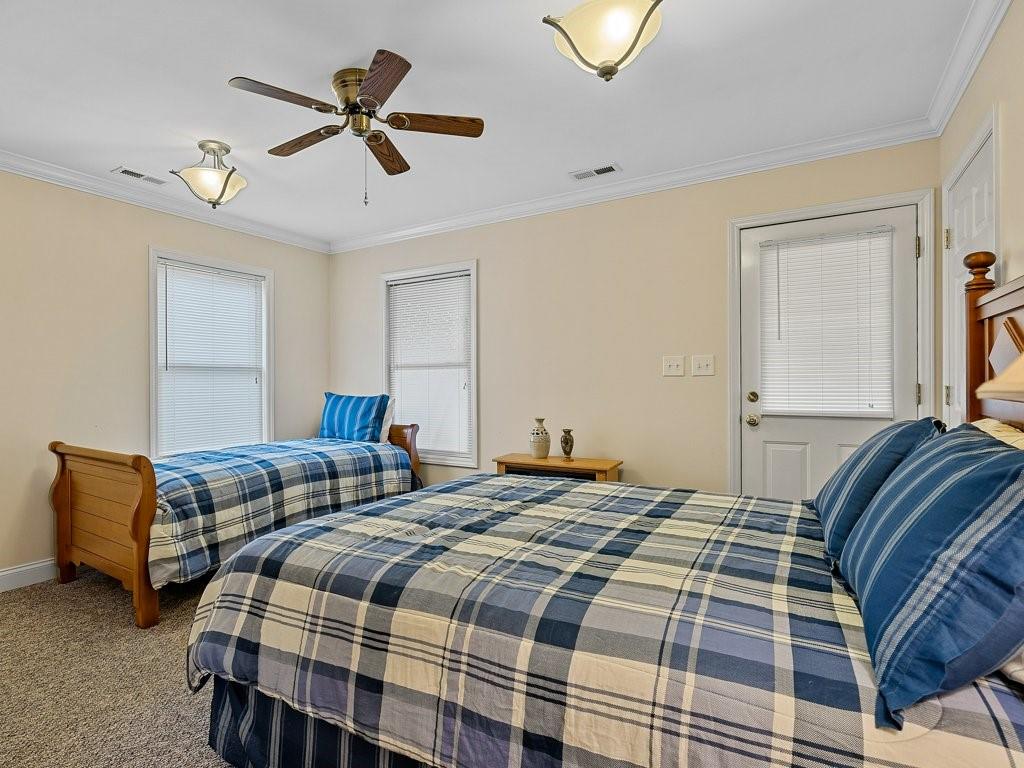 3245 Holly Road Connelly Springs, NC 28612 - Photo 17 of 39 a bedroom with bed and a chandelier