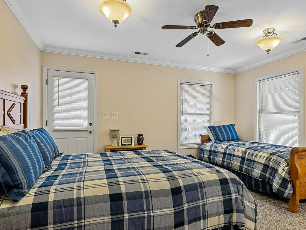 3245 Holly Road Connelly Springs, NC 28612 - Photo 19 of 39 a bedroom with bed and a chandelier