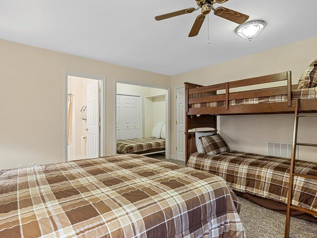 3245 Holly Road Connelly Springs, NC 28612 - Photo 22 of 39 a bedroom with a bed and walk in closet with wooden floor