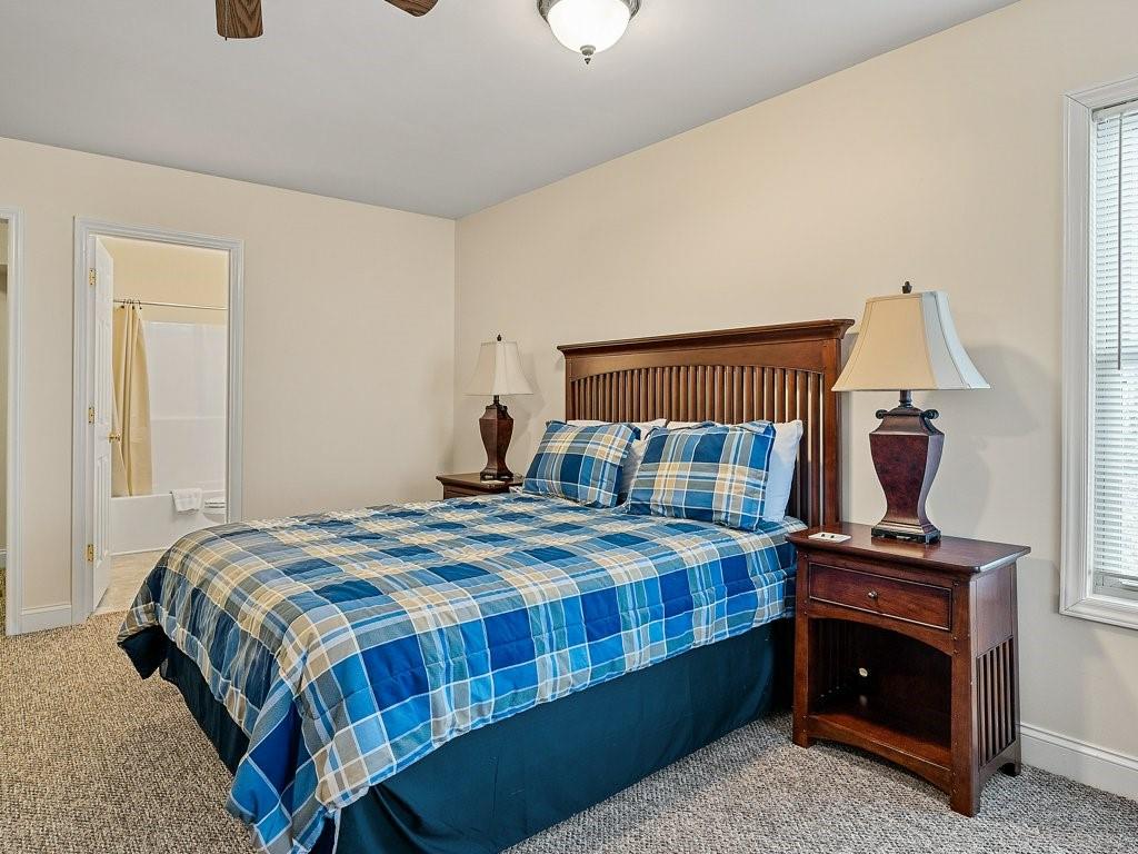 3245 Holly Road Connelly Springs, NC 28612 - Photo 26 of 39 a bedroom with a bed and a lamp on table