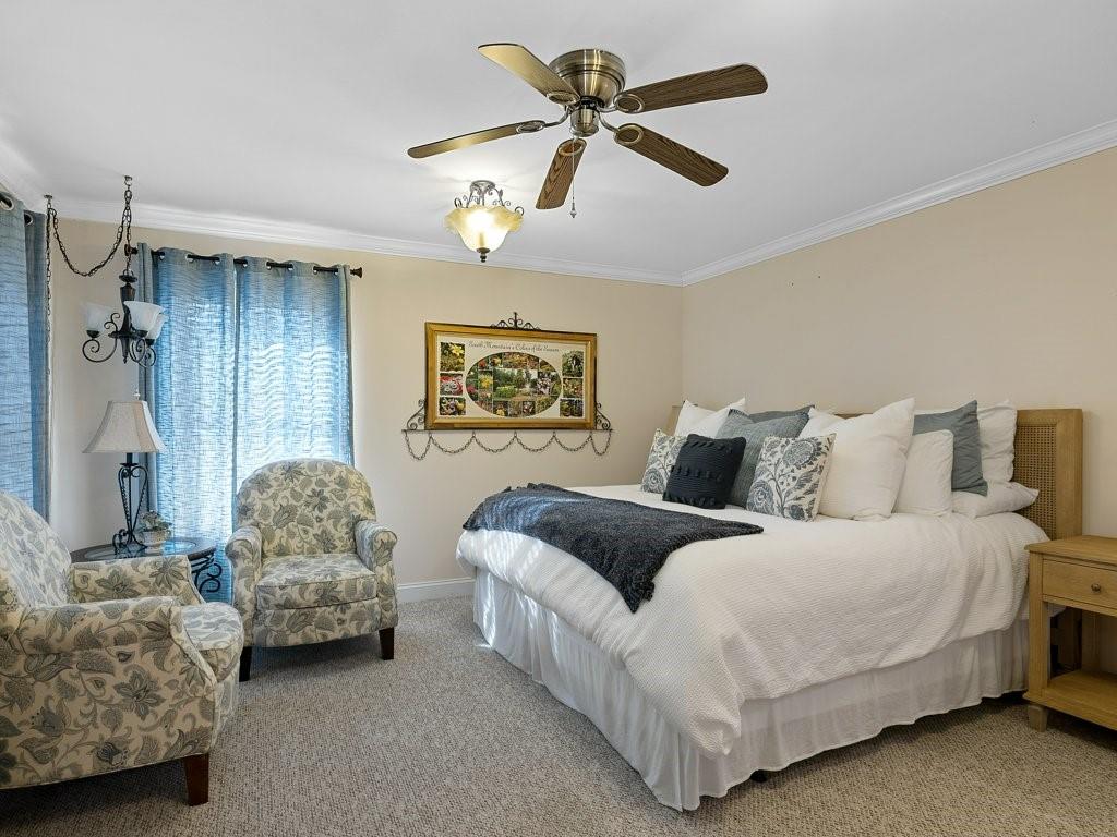 3245 Holly Road Connelly Springs, NC 28612 - Photo 6 of 39 a spacious bedroom with a bed and a chandelier