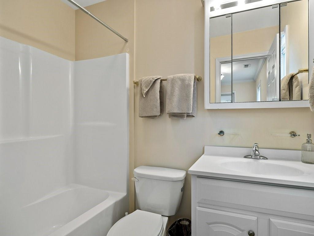 3245 Holly Road Connelly Springs, NC 28612 - Photo 7 of 39 a bathroom with a sink a mirror and a toilet
