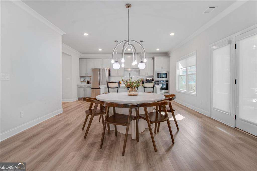 338 Ryston Way Grayson, GA 30017 - Photo 16 of 61 a view of a dining room with furniture window and wooden floor