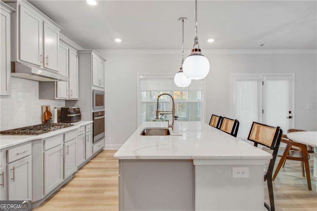 338 Ryston Way Grayson, GA 30017 - Photo 20 of 61 a kitchen with cabinets a sink and appliances