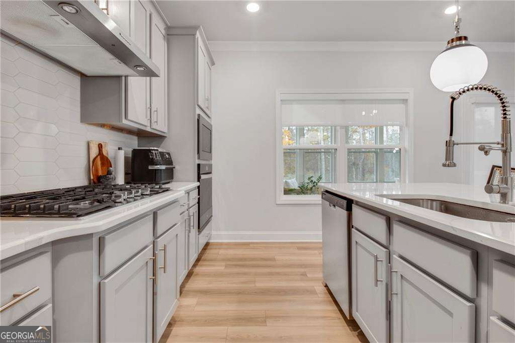 338 Ryston Way Grayson, GA 30017 - Photo 21 of 61 a kitchen with stainless steel appliances a sink stove and cabinets
