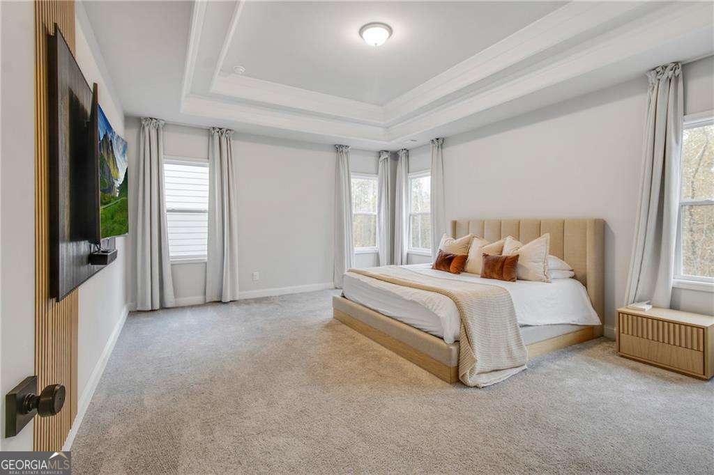 338 Ryston Way Grayson, GA 30017 - Photo 22 of 61 a spacious bedroom with a bed and a large window