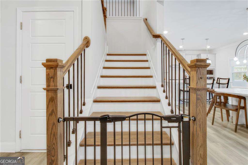 338 Ryston Way Grayson, GA 30017 - Photo 23 of 61 a view of staircase with lots of frames on wall and a window