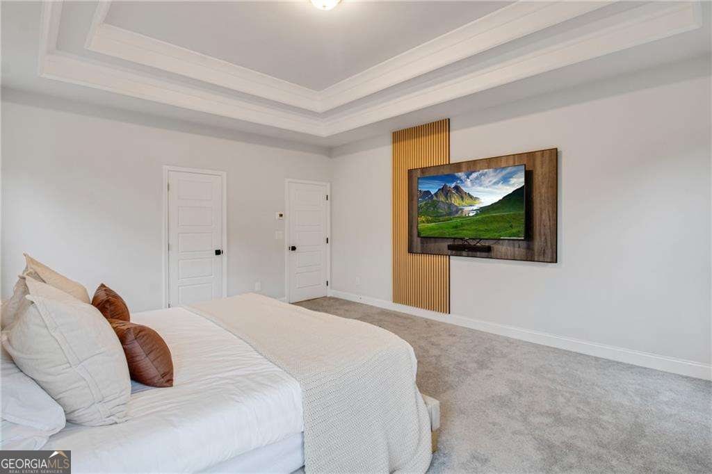 338 Ryston Way Grayson, GA 30017 - Photo 24 of 61 a bedroom with a bed and a painting on the wall