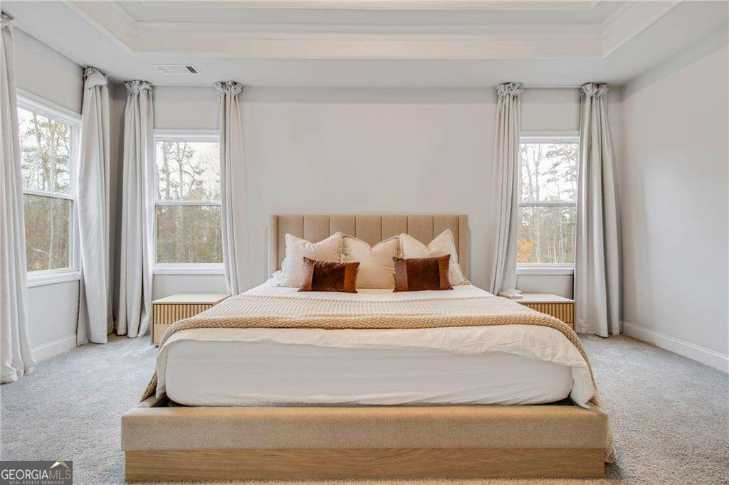 338 Ryston Way Grayson, GA 30017 - Photo 25 of 61 a bedroom with a large bed and a window