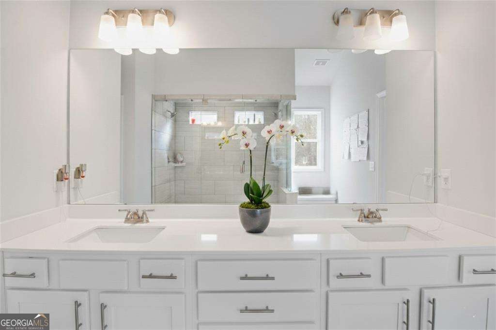 338 Ryston Way Grayson, GA 30017 - Photo 27 of 61 a bathroom with a sink double vanity and a mirror