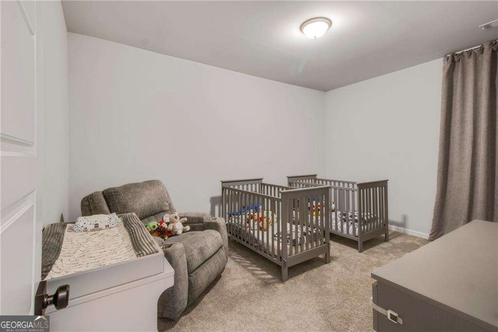 338 Ryston Way Grayson, GA 30017 - Photo 31 of 61 a bedroom with furniture and a window