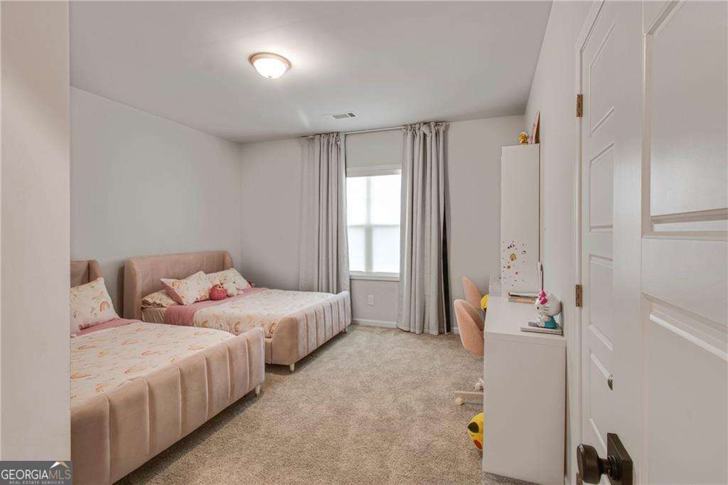 338 Ryston Way Grayson, GA 30017 - Photo 33 of 61 a bedroom with two beds and a window