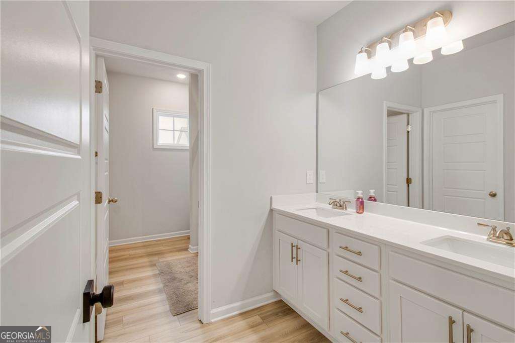 338 Ryston Way Grayson, GA 30017 - Photo 36 of 61 a bathroom with double vanity sink and a mirror