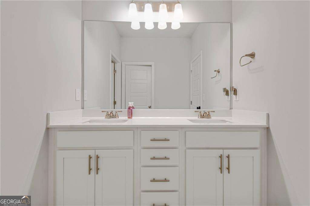 338 Ryston Way Grayson, GA 30017 - Photo 38 of 61 a bathroom with a sink vanity and a mirror